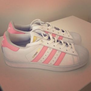 Never worn adidas with pink stripe